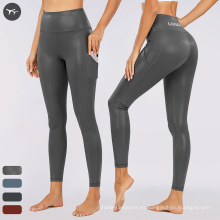 Ropa de fitness deportivo en relieve brillante en relieve de yoga para mujeres Logotipo de cintura personalizada Leggings de yoga ropa al aire libre